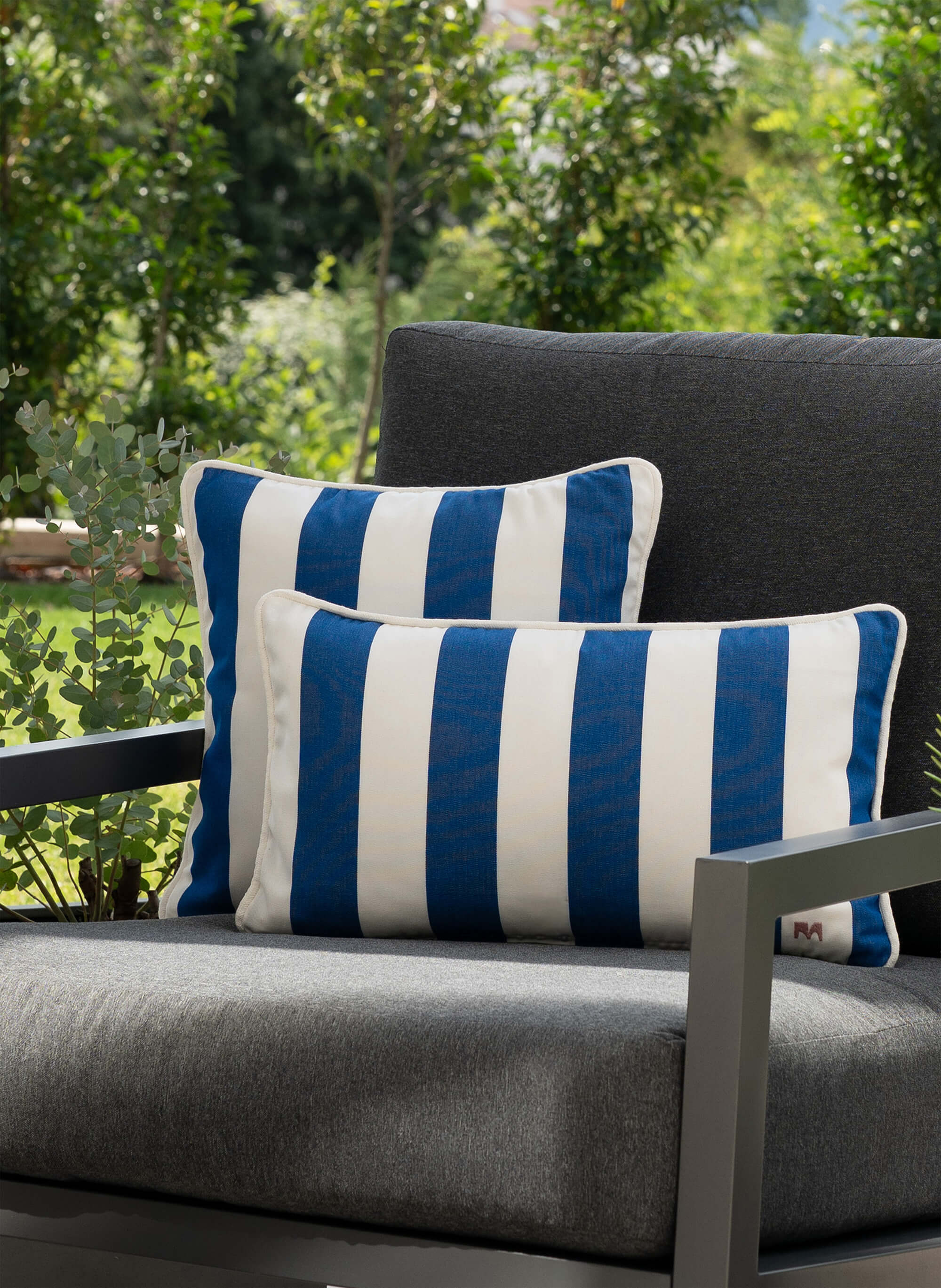 another mondaen Outdoor Kissen Classic Striped Blue auf moderner Gartenlounge – gestreifte Designkissen für Terrasse und Garten