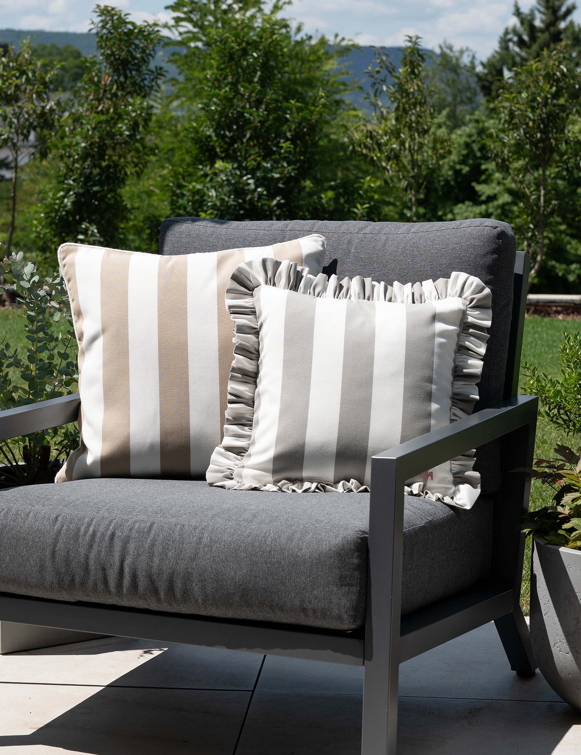 another mondaen Outdoor Kissen Classic Striped Taupe-Weiß und Ruffled Charm in grau-Weiß auf Gartenlounge – gestreifte Designkissen für Terrasse und Garten aus der VACANCES Kollektion
